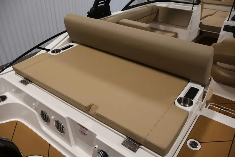 Slide: The Image of 2026 Bayliner D20 boat interior with beige seating and cup holders. - 26