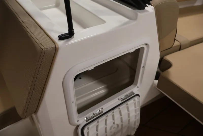 Slide: The Image of 2026 Bayliner D20 boat interior storage compartment with beige seating. - 21