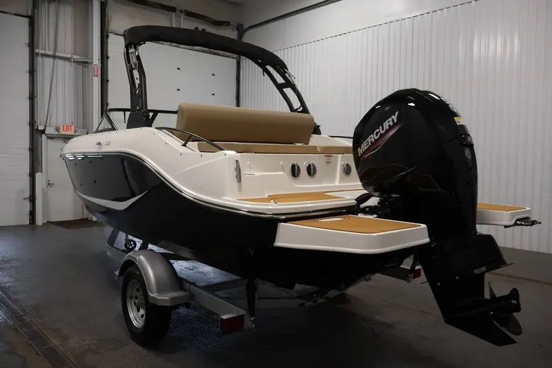 Slide: The Image of 2026 Bayliner D20 boat with Mercury outboard motor in a garage setting. - 37