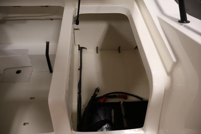 Slide: The Image of 2026 Bayliner D20 boat storage compartment with cables and equipment. - 29