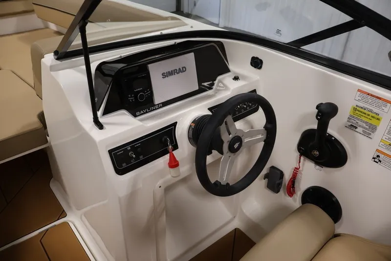 Slide: The Image of 2026 Bayliner D20 boat cockpit with steering wheel and Simrad navigation system. - 14