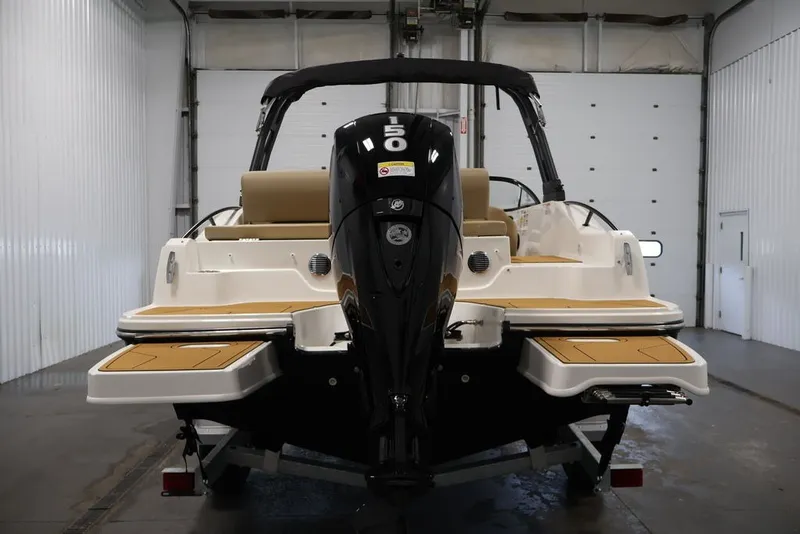 Slide: The Image of 2026 Bayliner D20 boat in a garage, showcasing rear view and motor. - 8