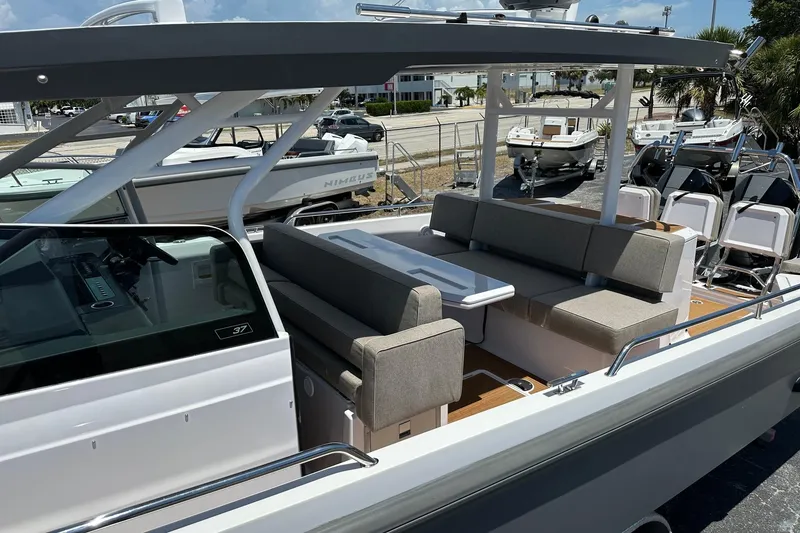 Slide: The Image of 2024 Axopar 37 Sun-Top boat with spacious seating and modern design. - 14