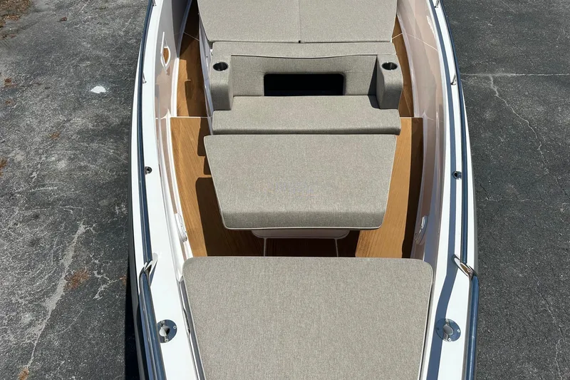 Slide: The Image of 2024 Axopar 37 Sun-Top boat with spacious sunbathing area and cushioned seating. - 16