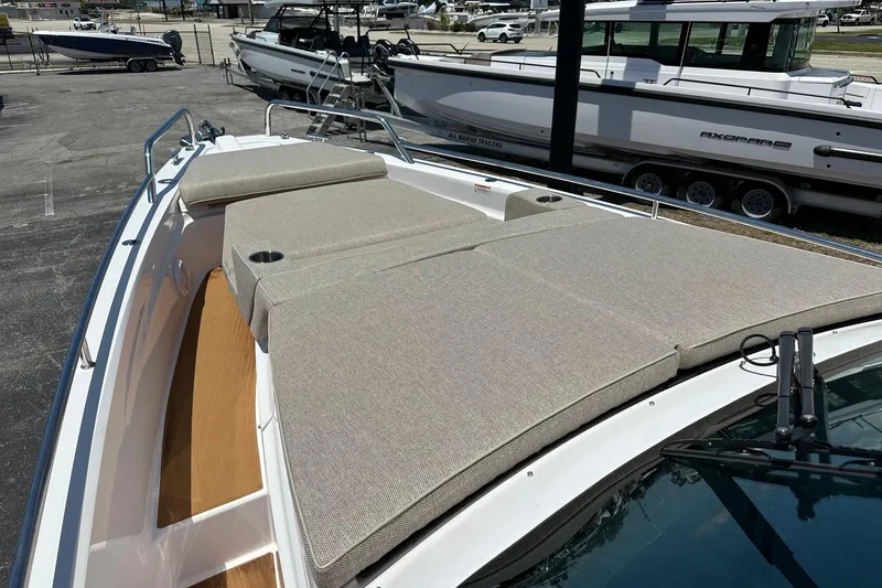 Slide: The Image of 2024 Axopar 37 Sun-Top boat with spacious sunbathing area and sleek design. - 18