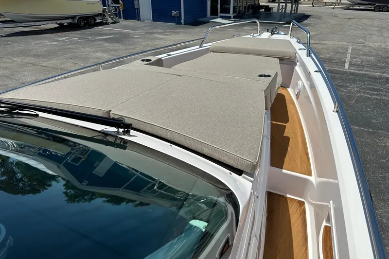 Slide: The Image of 2024 Axopar 37 Sun-Top boat with spacious sunbathing area and sleek design. - 19