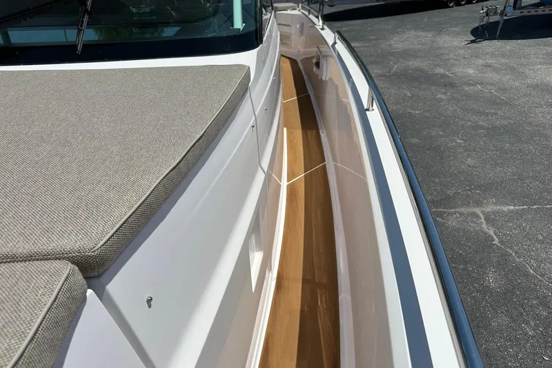Slide: The Image of 2024 Axopar 37 Sun-Top boat deck with cushioned seating and sleek design. - 20