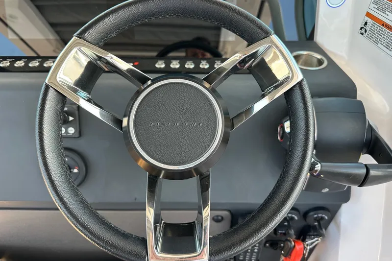 Slide: The Image of Steering wheel of 2024 Axopar 37 Sun-Top boat, featuring sleek design and controls. - 25