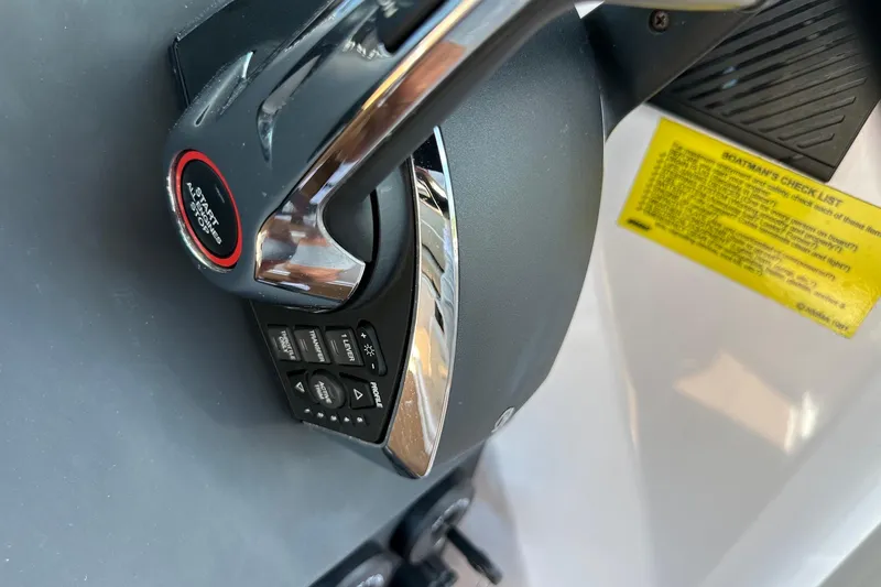 Slide: The Image of Close-up of 2024 Axopar 37 Sun-Top boat controls with start/stop button. - 27