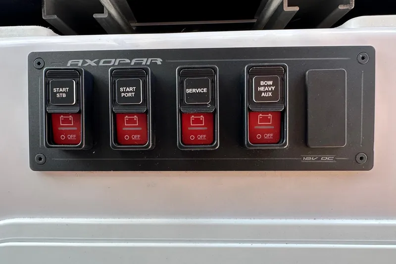 Slide: The Image of Control panel of 2024 Axopar 37 Sun-Top boat with labeled switches. - 30