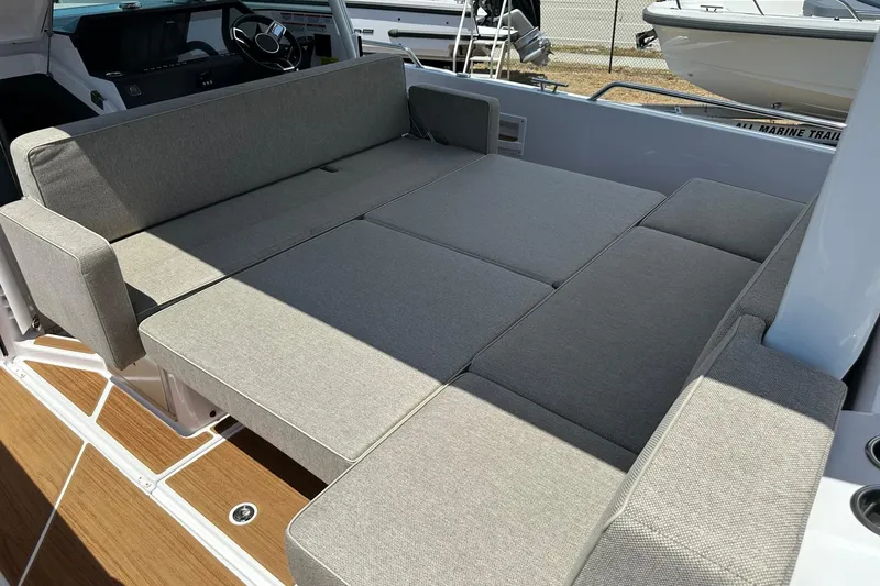 Slide: The Image of 2024 Axopar 37 Sun-Top boat interior with spacious gray seating area. - 35