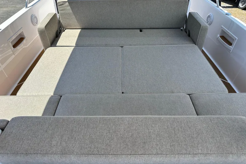 Slide: The Image of 2024 Axopar 37 Sun-Top boat interior with spacious gray seating area. - 36