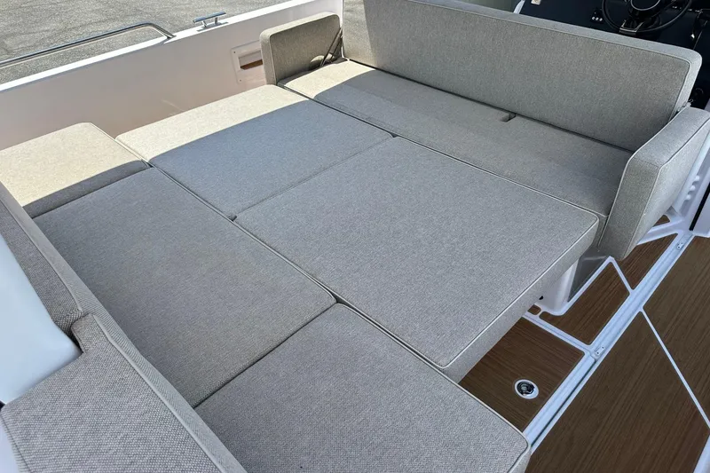 Slide: The Image of 2024 Axopar 37 Sun-Top boat interior with convertible seating and modern design. - 37