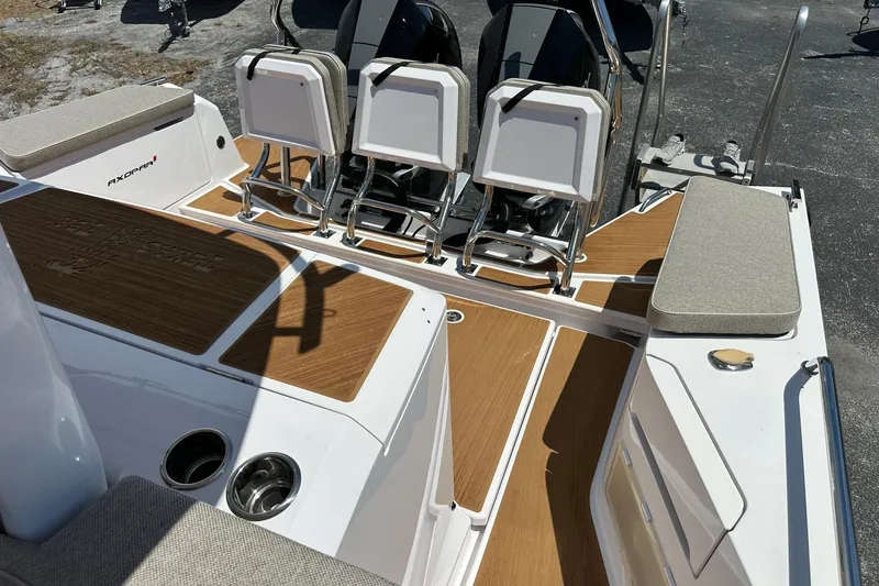 Slide: The Image of 2024 Axopar 37 Sun-Top boat interior with seating and teak flooring. - 38