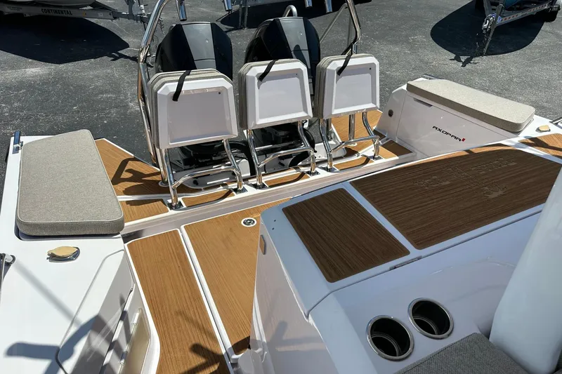 Slide: The Image of 2024 Axopar 37 Sun-Top boat interior with seating and teak flooring. - 39