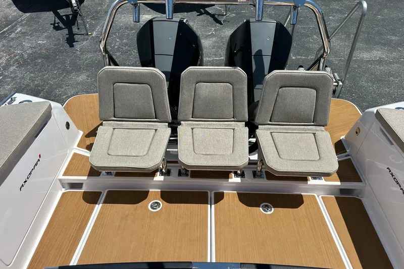 Slide: The Image of 2024 Axopar 37 Sun-Top boat with three cushioned seats on teak deck. - 41