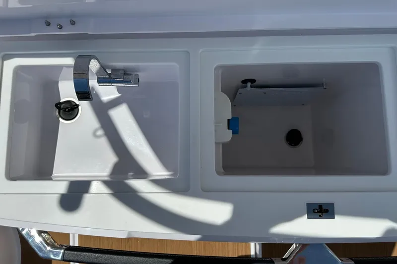 Slide: The Image of 2024 Axopar 37 Sun-Top boat sink and storage compartments in white finish. - 44