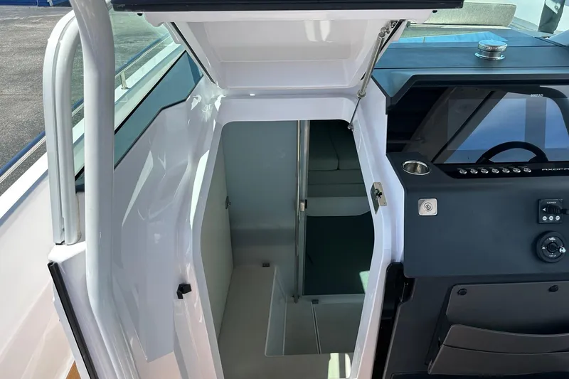 Slide: The Image of 2024 Axopar 37 Sun-Top cabin entrance and helm station interior view. - 47