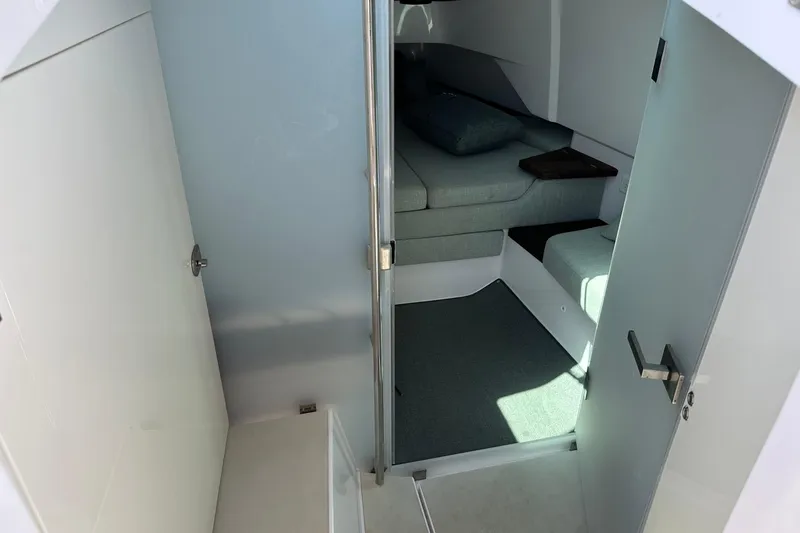 Slide: The Image of 2024 Axopar 37 Sun-Top cabin interior with modern seating and minimalist design. - 48