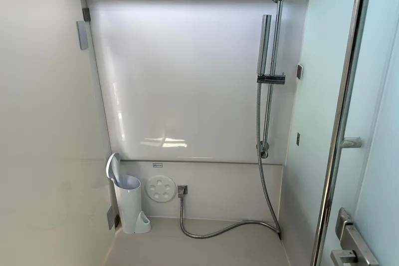 Slide: The Image of 2024 Axopar 37 Sun-Top shower area with modern fixtures and sleek design. - 51