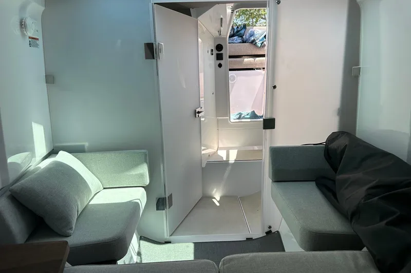 Slide: The Image of Interior of 2024 Axopar 37 Sun-Top boat with modern seating and natural light. - 53