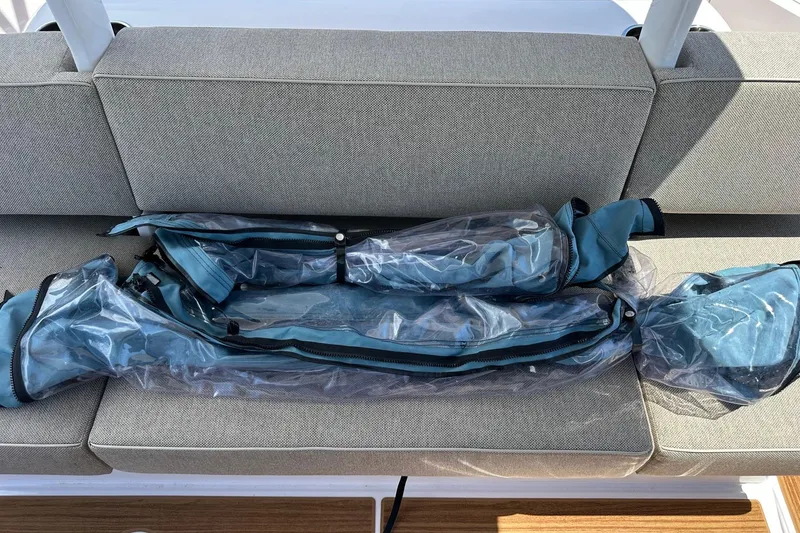 Slide: The Image of 2024 Axopar 37 Sun-Top boat seat with protective cover on gray upholstery. - 54