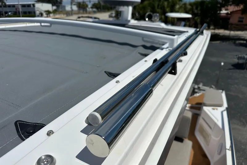 Slide: The Image of 2024 Axopar 37 Sun-Top boat with sleek stainless steel railings and sunroof detail. - 57