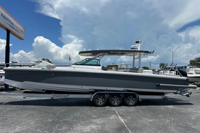 Slide: The Image of 2024 Axopar 37 Sun-Top boat on trailer at Nautical Ventures Marine Center. - 6