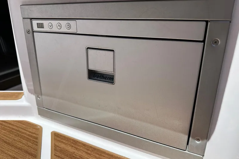 Slide: The Image of Built-in cooler on 2024 Axopar 37 Sun-Top boat, featuring sleek stainless steel design. - 60