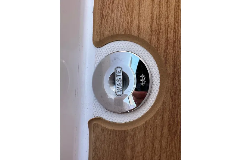 Slide: The Image of Waste cap on 2024 Axopar 37 Sun-Top boat, featuring wood-textured deck. - 63