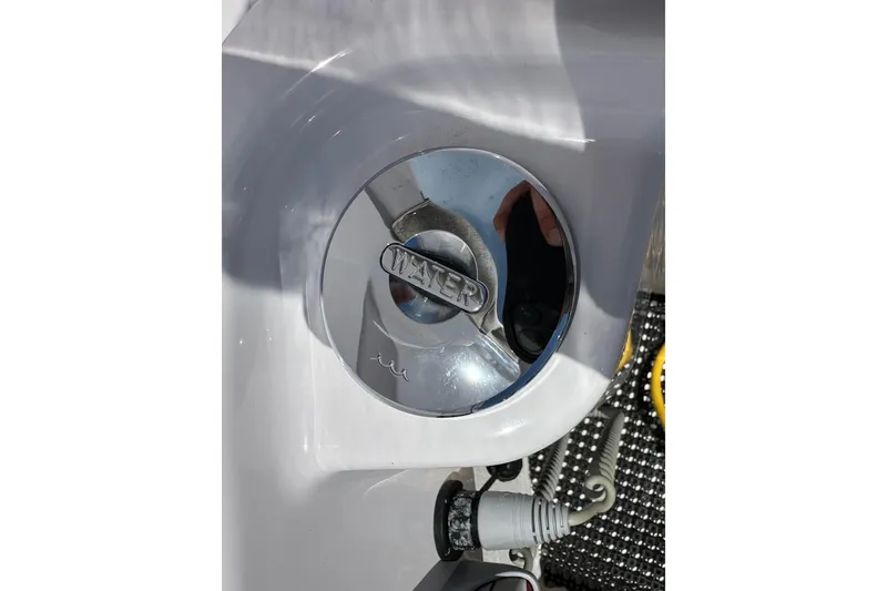 Slide: The Image of Close-up of a 2024 Axopar 37 Sun-Top boat's water inlet cap. - 64
