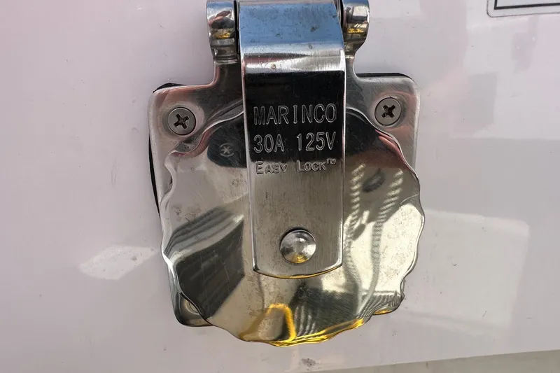 Slide: The Image of Marinco 30A 125V Easy Lock outlet on 2024 Axopar 37 Sun-Top boat. - 65