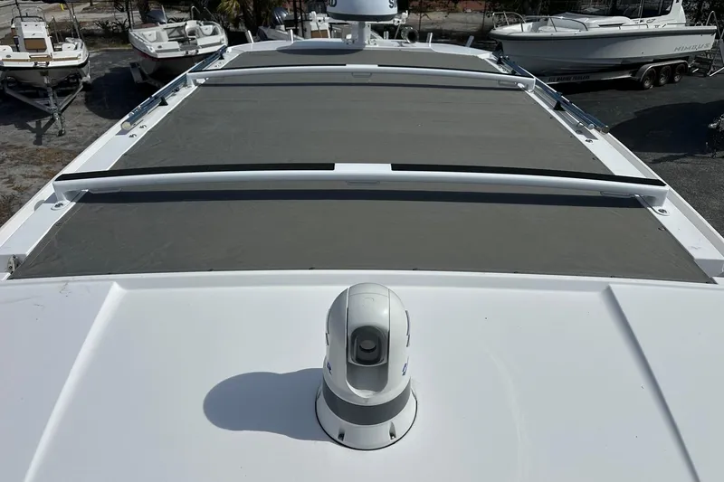 Slide: The Image of 2024 Axopar 37 Sun-Top boat roof with sunshade and radar equipment. - 66