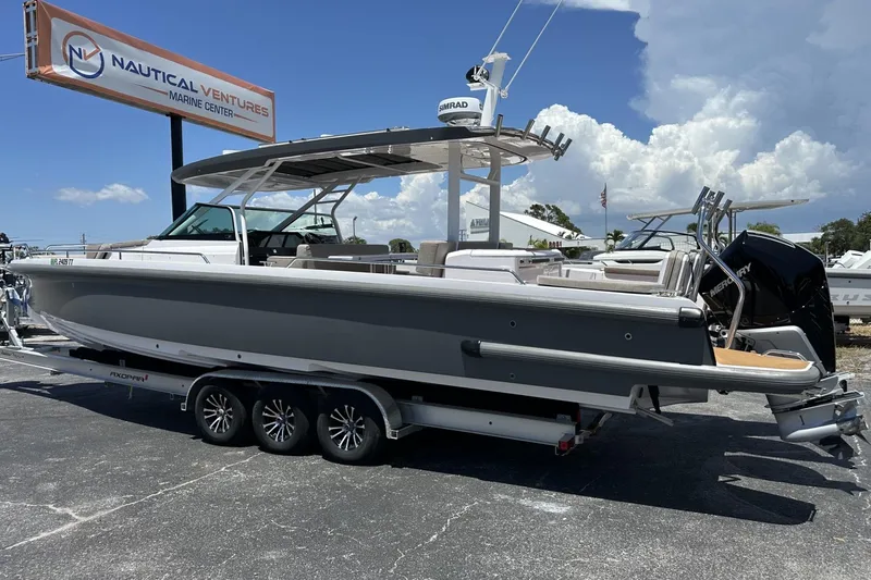 Slide: The Image of 2024 Axopar 37 Sun-Top boat at Nautical Ventures Marine Center, featuring sleek design and powerful engine. - 7