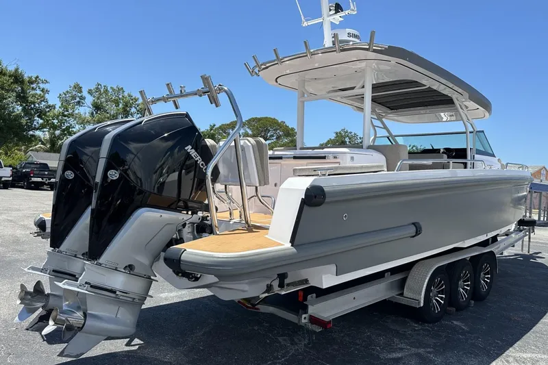 Slide: The Image of 2024 Axopar 37 Sun-Top boat with dual Mercury engines on a trailer. - 9