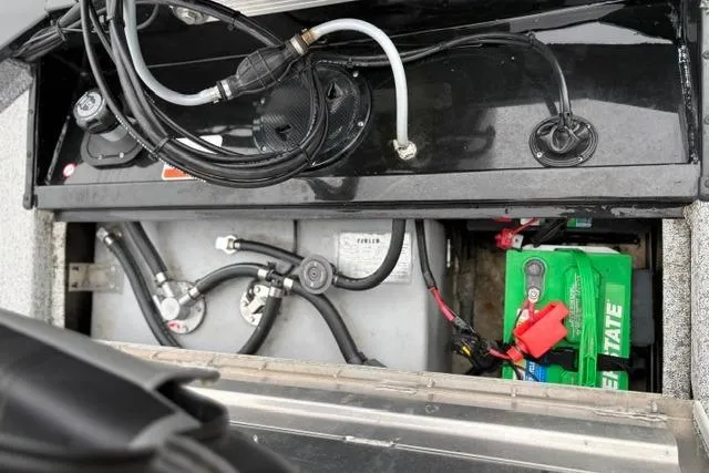 Slide: The Image of 2023 Tracker Pro 170 boat battery and wiring compartment, showcasing cables and connections. - 15