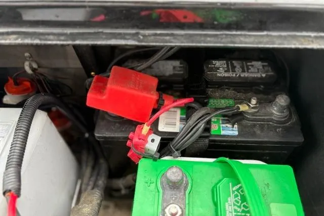 Slide: The Image of Battery compartment of 2023 Tracker Pro 170 boat with visible wiring connections. - 20