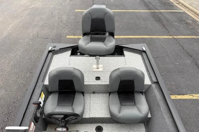 Slide: The Image of 2023 Tracker Pro 170 boat interior with three gray seats on a textured deck. - 22