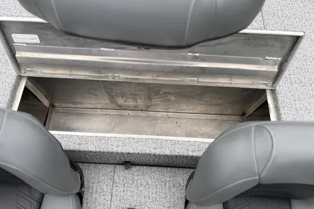 Slide: The Image of 2023 Tracker Pro 170 boat storage compartment with gray seating and open hatch. - 29
