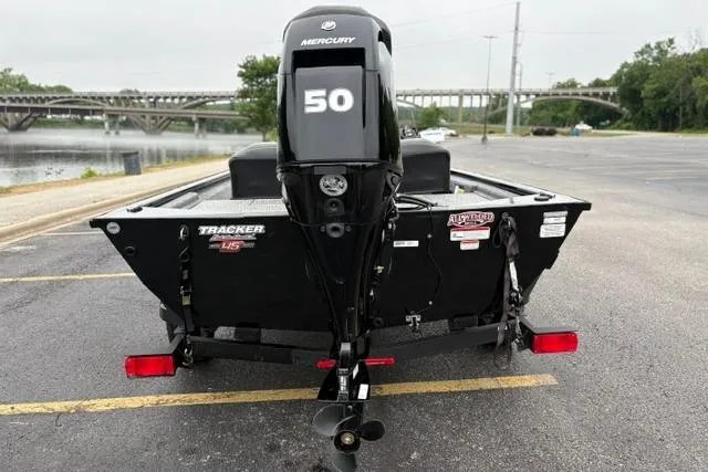 Slide: The Image of 2023 Tracker Pro 170 boat with Mercury 50 engine, parked near a river. - 32