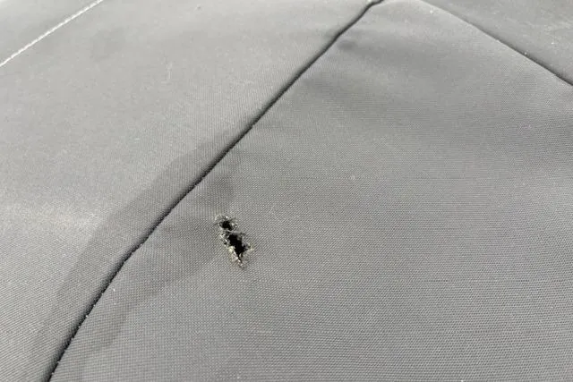 Slide: The Image of A small tear on the fabric of a 2023 Tracker Pro 170 boat seat. - 40