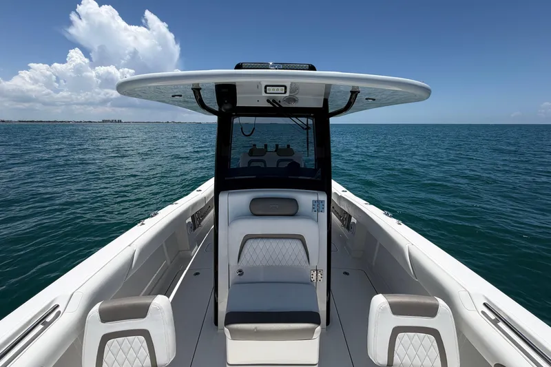 Slide: The Image of 2023 World Cat 280 CC-X boat on open sea under clear blue sky. - 3