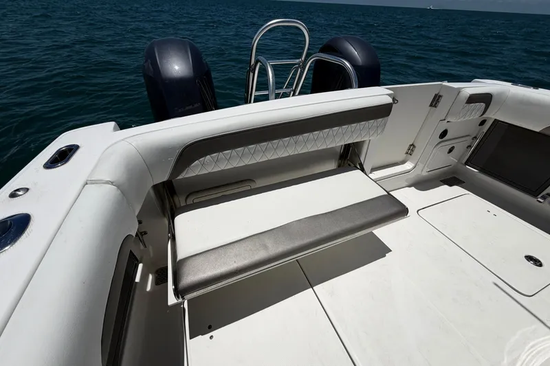 Slide: The Image of 2023 World Cat 280 CC-X boat interior with seating and ocean backdrop. - 8