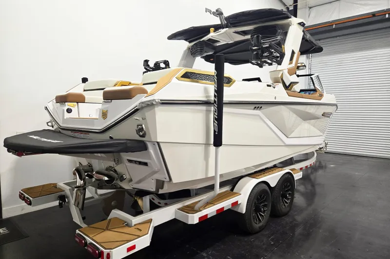 Slide: The Image of 2026 Nautique Super Air Nautique G23 Paragon boat on trailer in indoor storage. - 4
