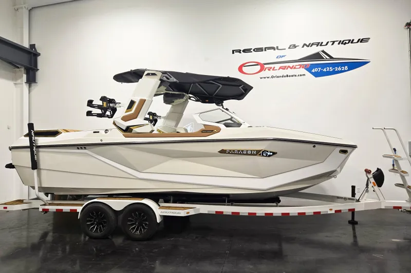 The Image of 2026 Nautique Super Air Nautique G23 Paragon boat on trailer in showroom. - 0