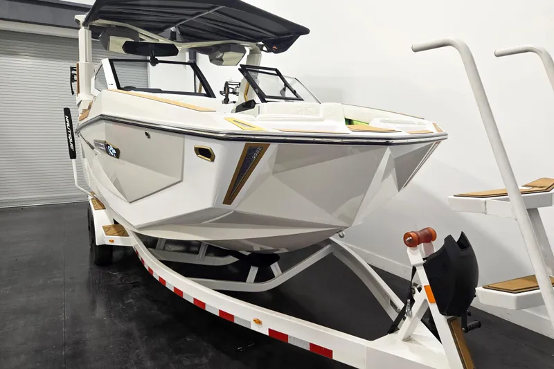 Slide: The Image of 2026 Nautique Super Air Nautique G23 Paragon boat on trailer in showroom. - 3