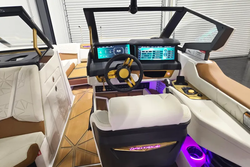 Slide: The Image of 2026 Nautique Super Air Nautique G23 Paragon interior with advanced dashboard and luxurious seating. - 16