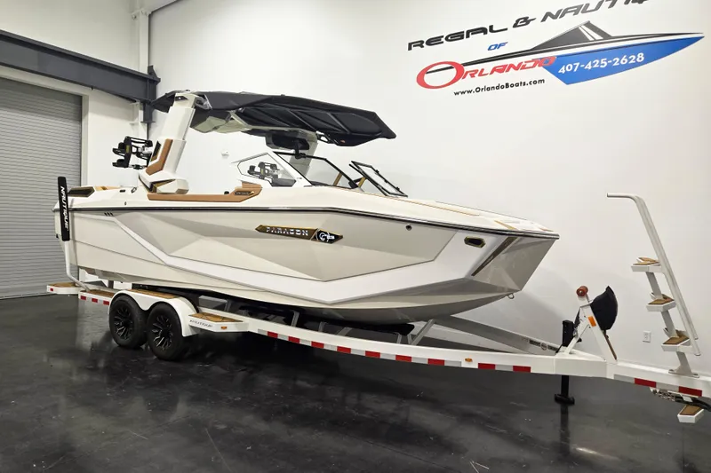 Slide: The Image of 2026 Nautique Super Air Nautique G23 Paragon boat on trailer in showroom. - 1