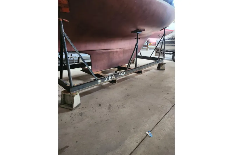 Slide: The Image of 1978 Columbia Yacht 10.7 on stand in a boatyard. - 14
