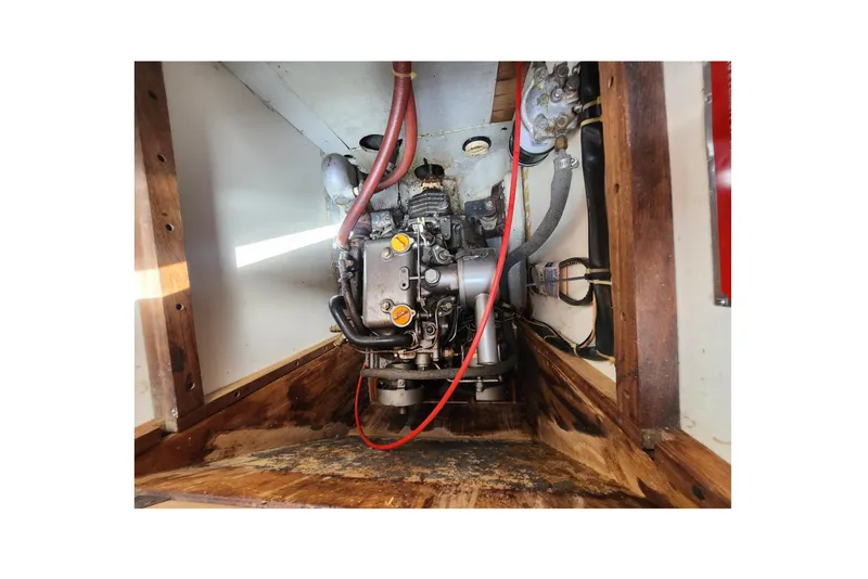 Slide: The Image of Engine compartment of a 1981 Columbia Yacht 10.7, showcasing mechanical components and wiring. - 15